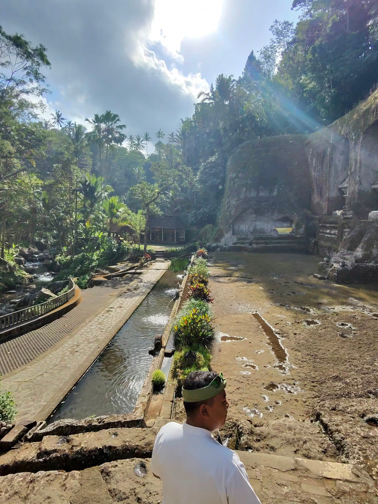 Sunlit approach to the Gunung Kawi rock-cut shrine with the temple guardian