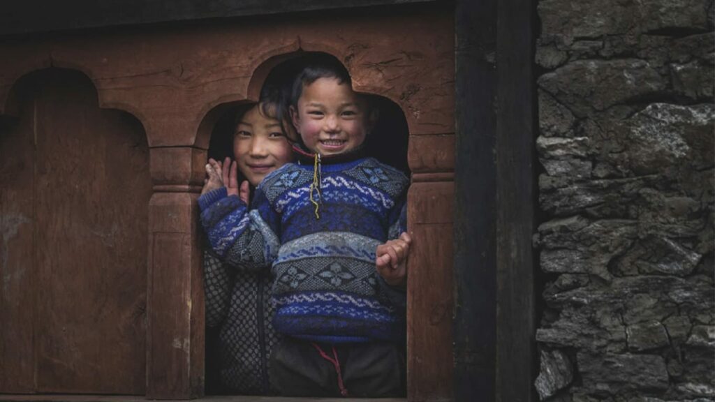 Bhutanese monastery with prayer flags overlooking a Himalayan valley